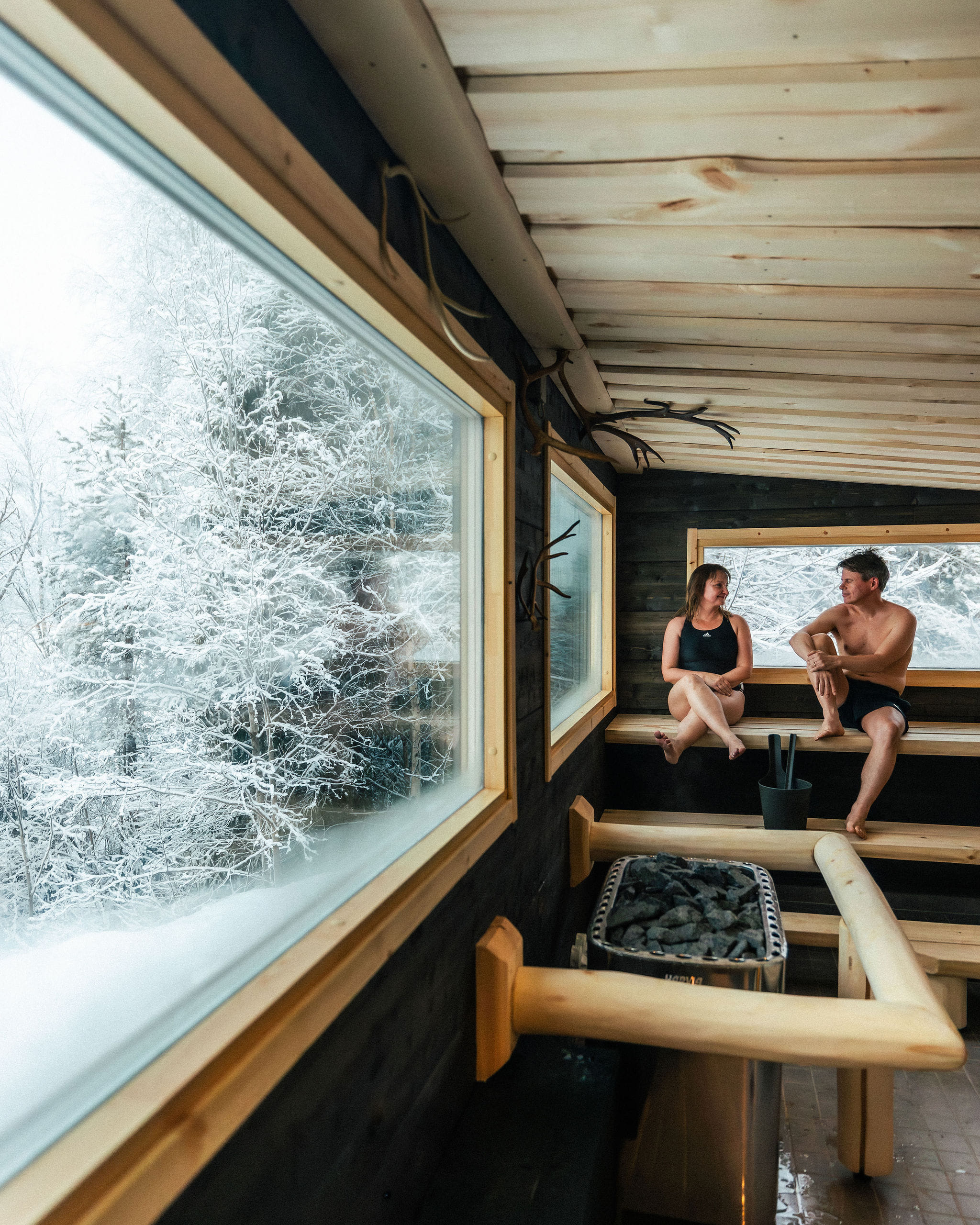 A couple enjoying a view from the sauna window