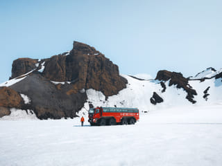 Monster truck standing on the glacier, Mount Insta Jarlhetta in the background