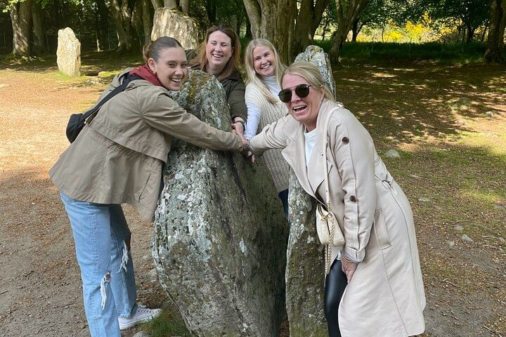 Group of Go Highlands Guests Holding Hands through time at the Clava Cairns split stone