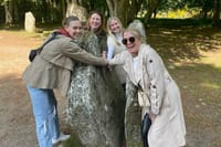 Group of Go Highlands Guests Holding Hands through time at the Clava Cairns split stone