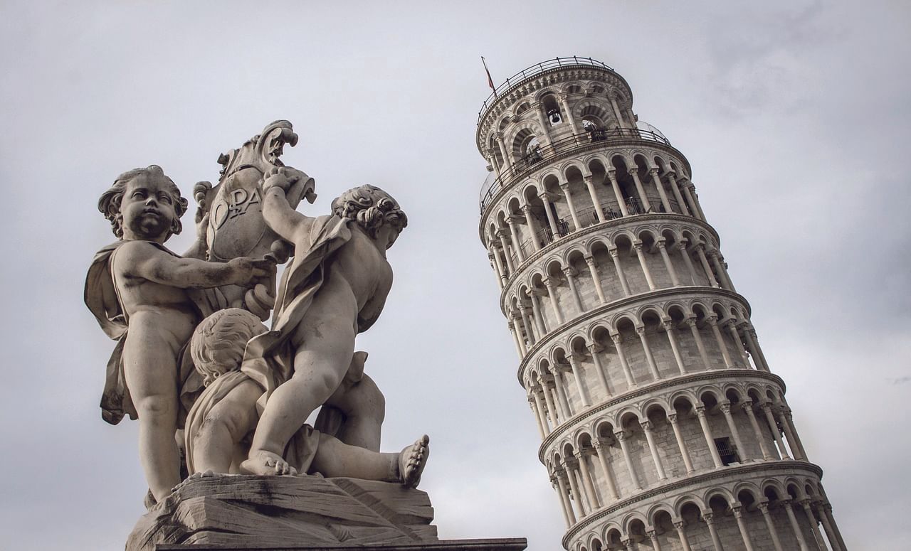 Leaning Tower of Pisa with a sculpture in the foreground