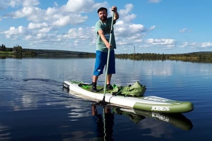 Arctic summer SUP boarding on a lake and river
