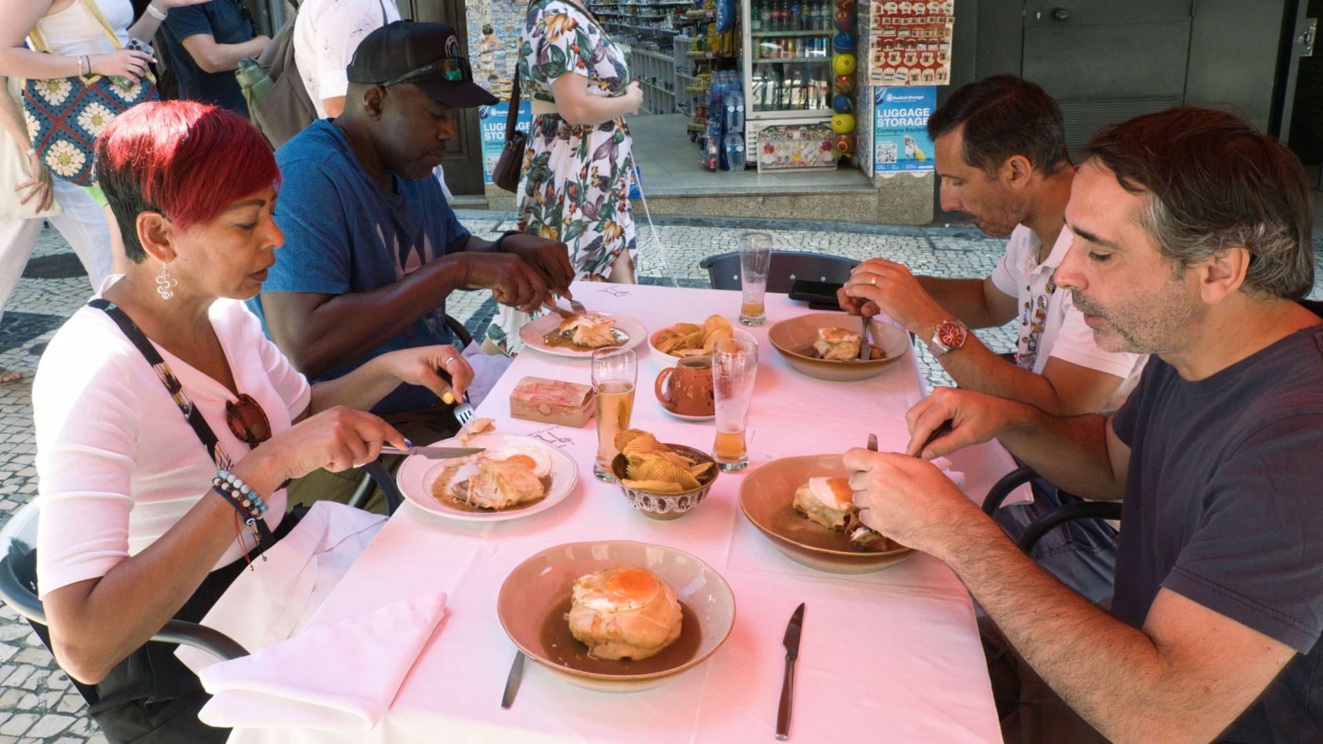 Guests enjoying authentic Francesinha sandwiches at a traditional restaurant in Porto, part of the Cooltour Oporto Food Tour