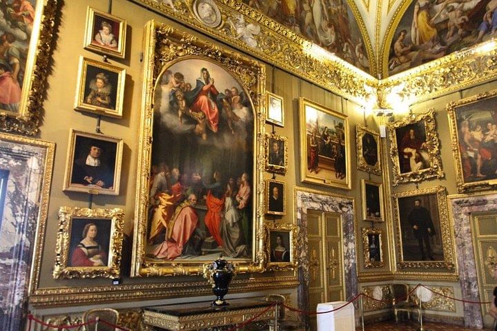 View of one of the halls of Palazzo Pitti with paintings on display 