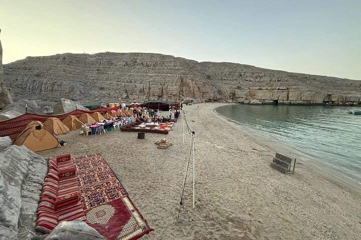 This is where you'll spend the night! Enjoy the cozy setup, traditional carpets, and stunning scenery right before your delicious BBQ Dinner on this Musandam Khasab Overnight experience.