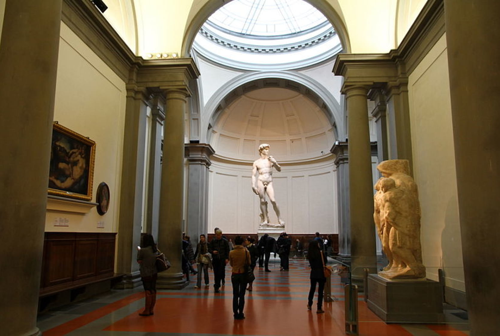 Tourists admiring the Michelangelo's David inside the Accademia Gallery 