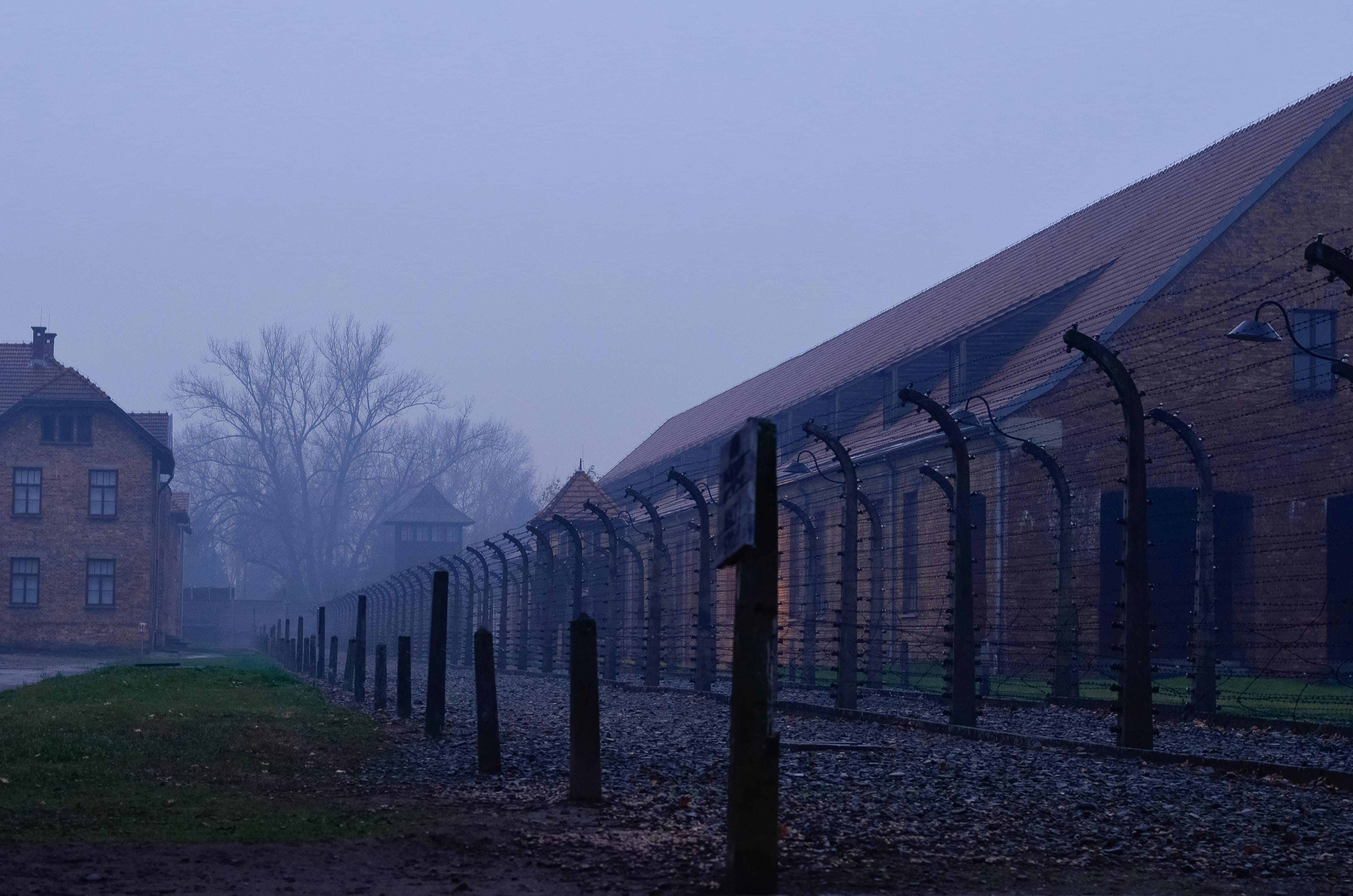 Side view of brick barracks at Auschwitz I Memorial at dusk