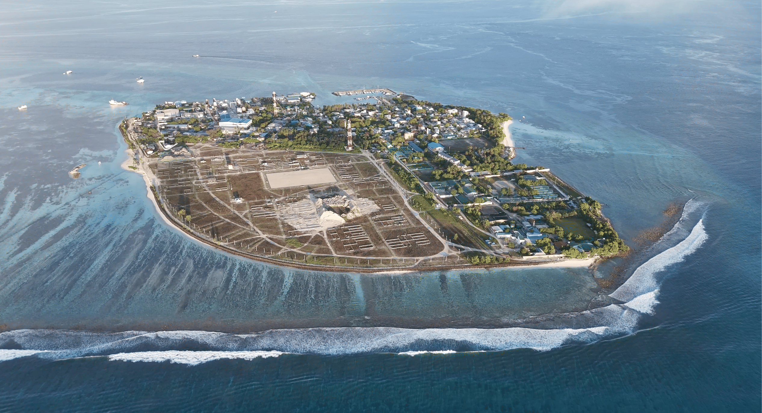 Drone shot of Himmafushi Island and Jailbreaks surf point in 2024, with surfers and clear blue waters