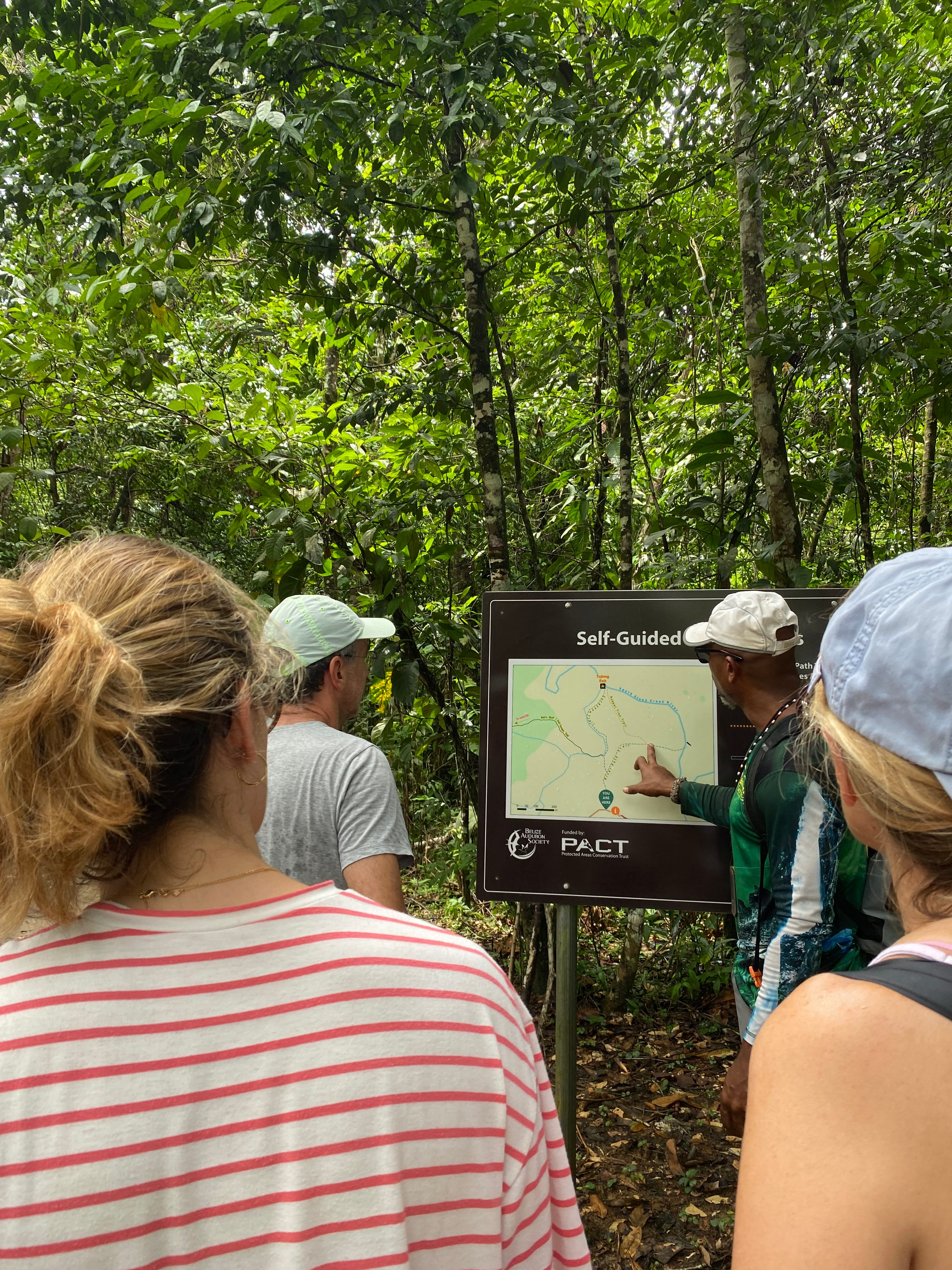 Tour guide in Belize Jaguar Preserve discussing the day's trail