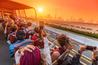 "Dubai's iconic skyline serves as the backdrop for tourists enjoying the Big Bus Tour, a fantastic way to explore."