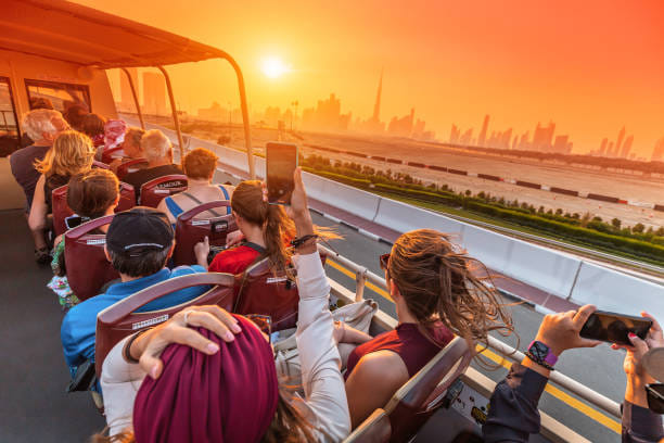 "Dubai's iconic skyline serves as the backdrop for tourists enjoying the Big Bus Tour, a fantastic way to explore."
