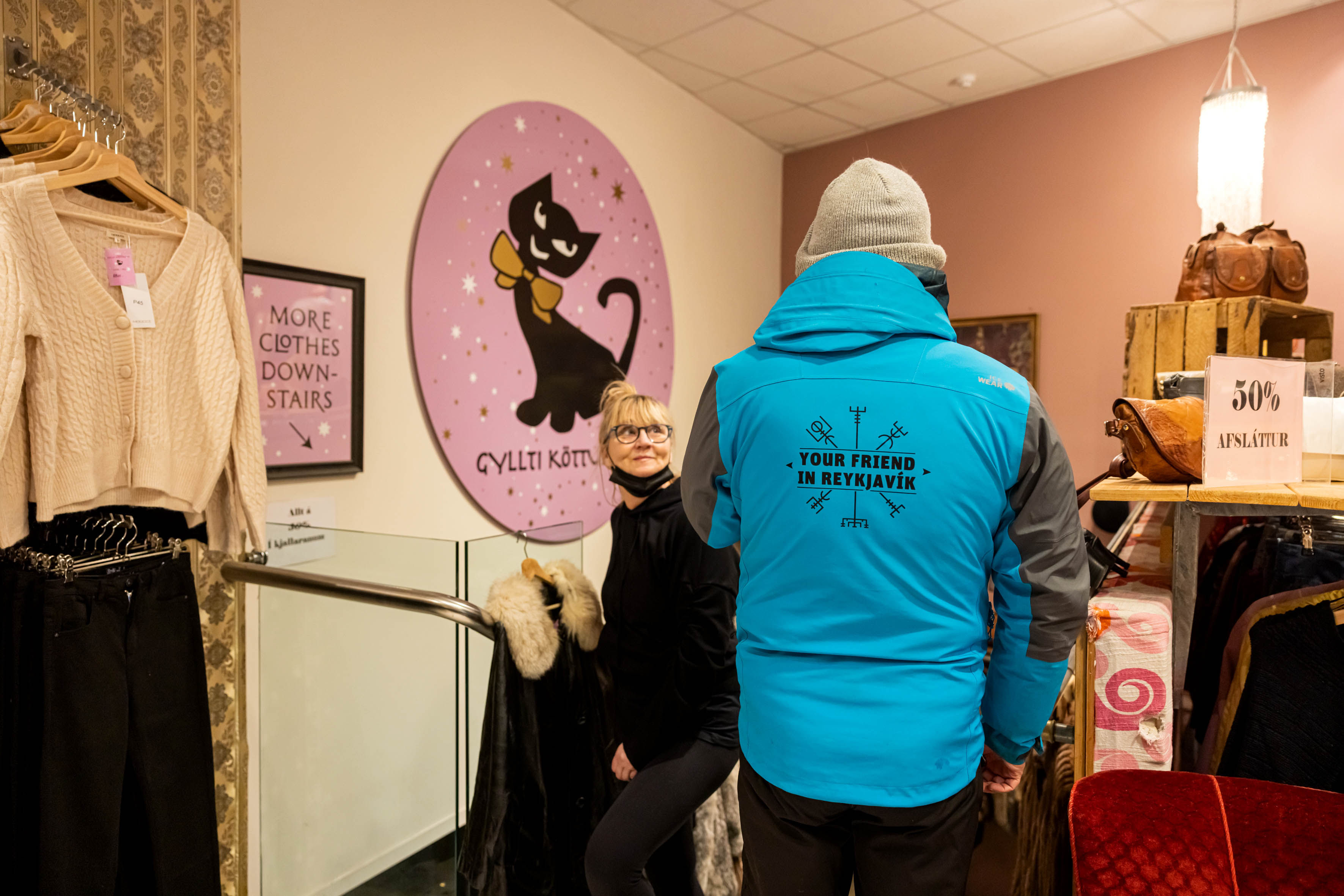 A guide from Your Friend in Reykjavik conversing with a staff member of the store displayed.