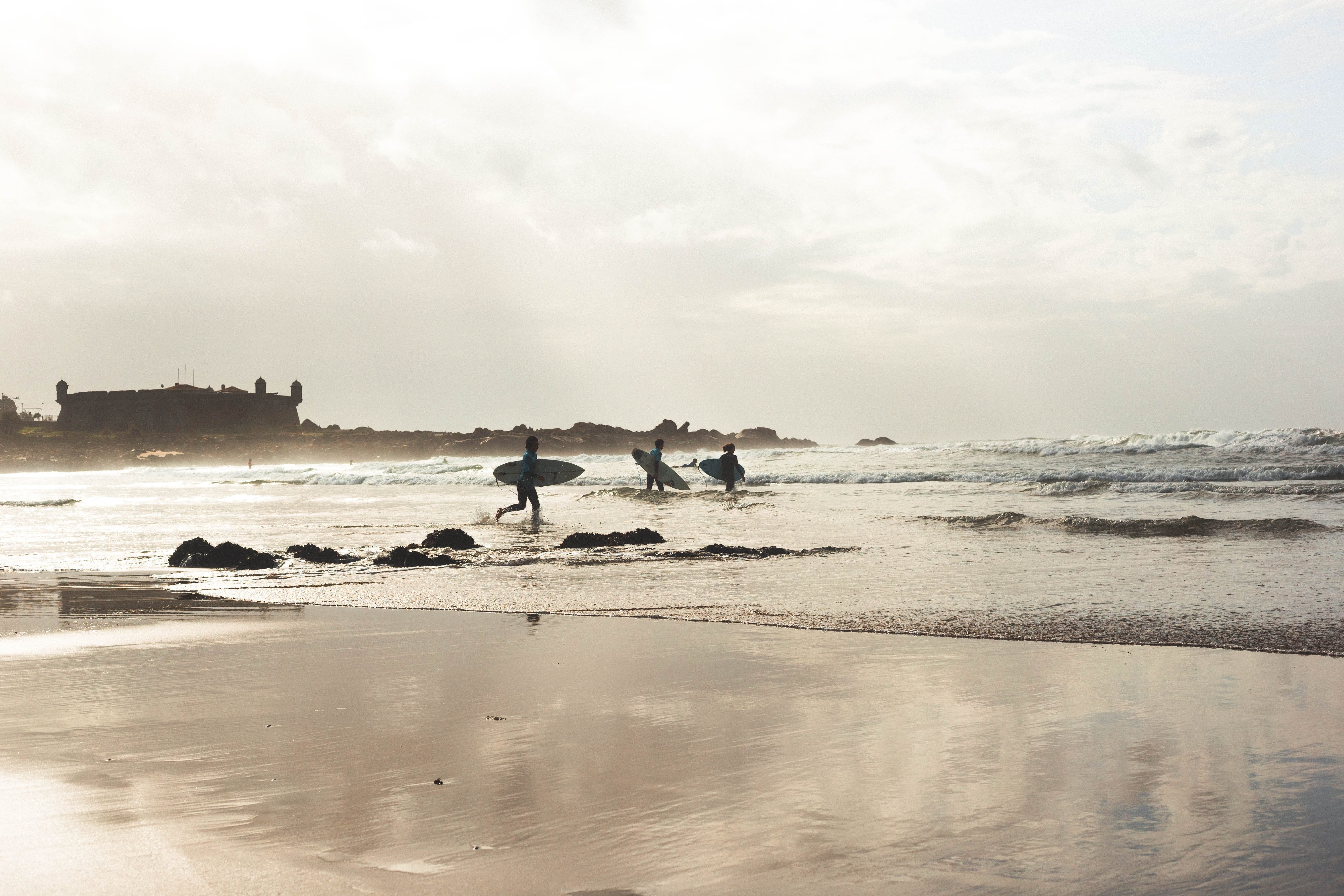Surfers catching waves at Matosinhos Beach.