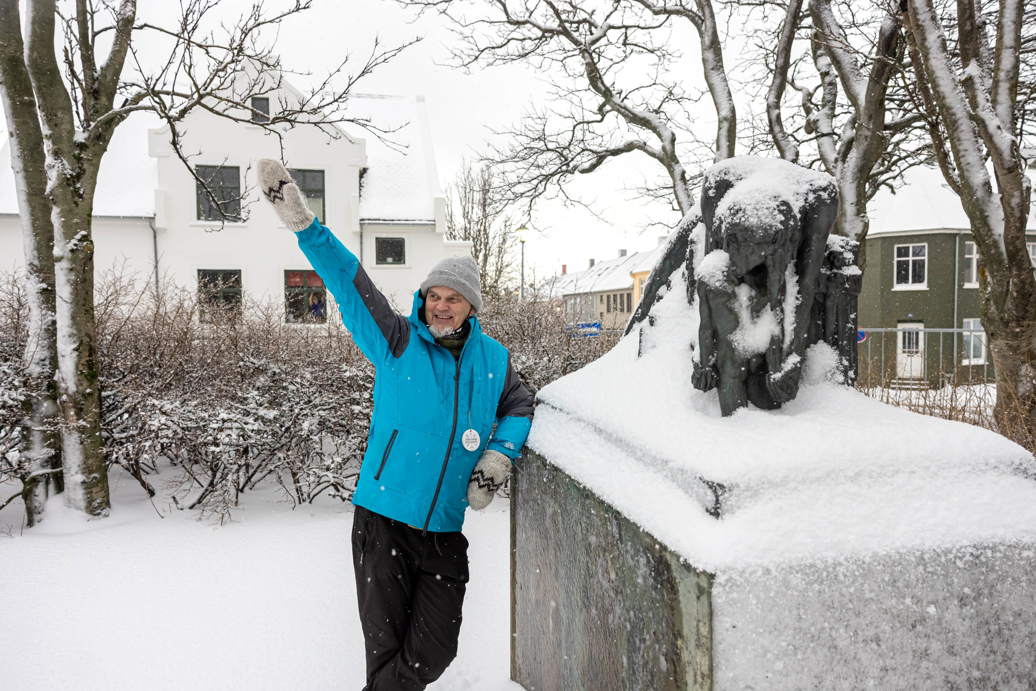 A guide from Your Friend in Reykjavik sharing a story about cats in front of a monument.