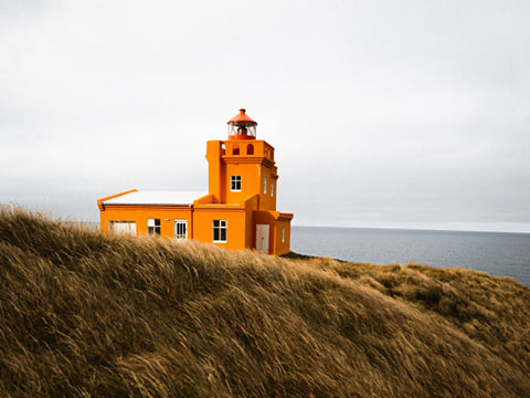Shot of a lighthouse along the Trollaskagi coastline