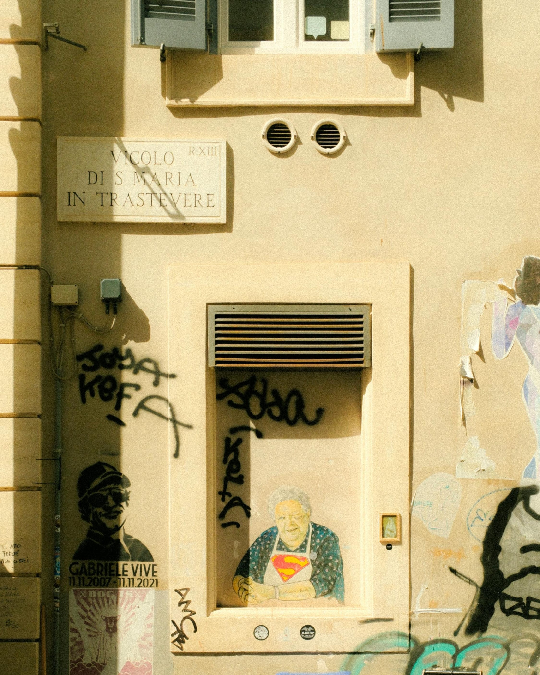 Trastevere in one frame—golden light, tight geometry, and the city’s rough poetry on the walls.