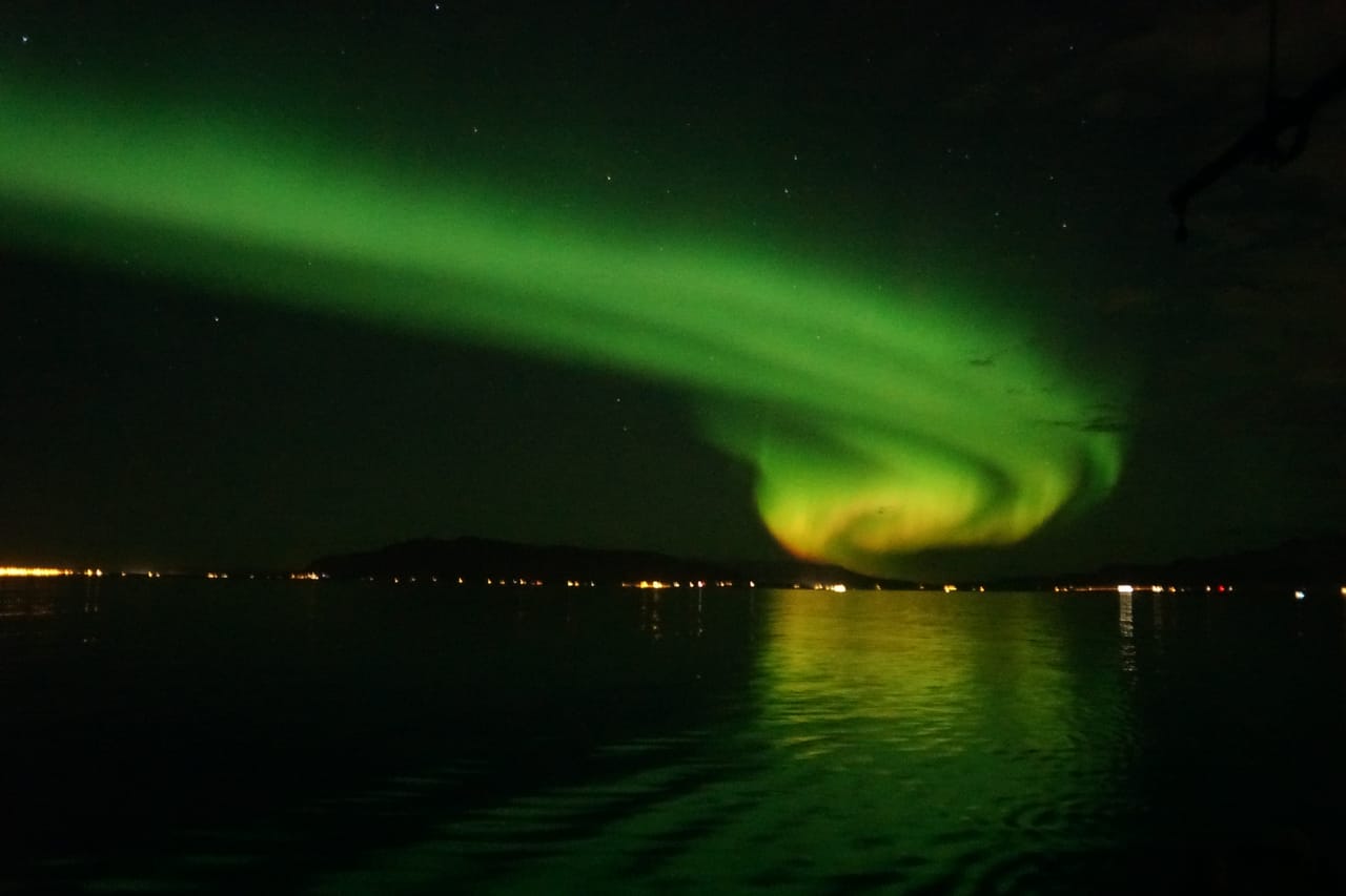 Travelers enjoying a Northern Lights boat tour near Reykjavík