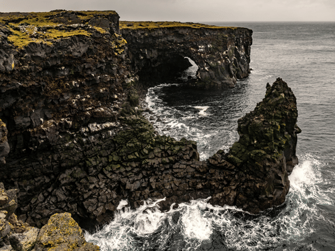 Svörtuloft black lava sea cliffs and arch