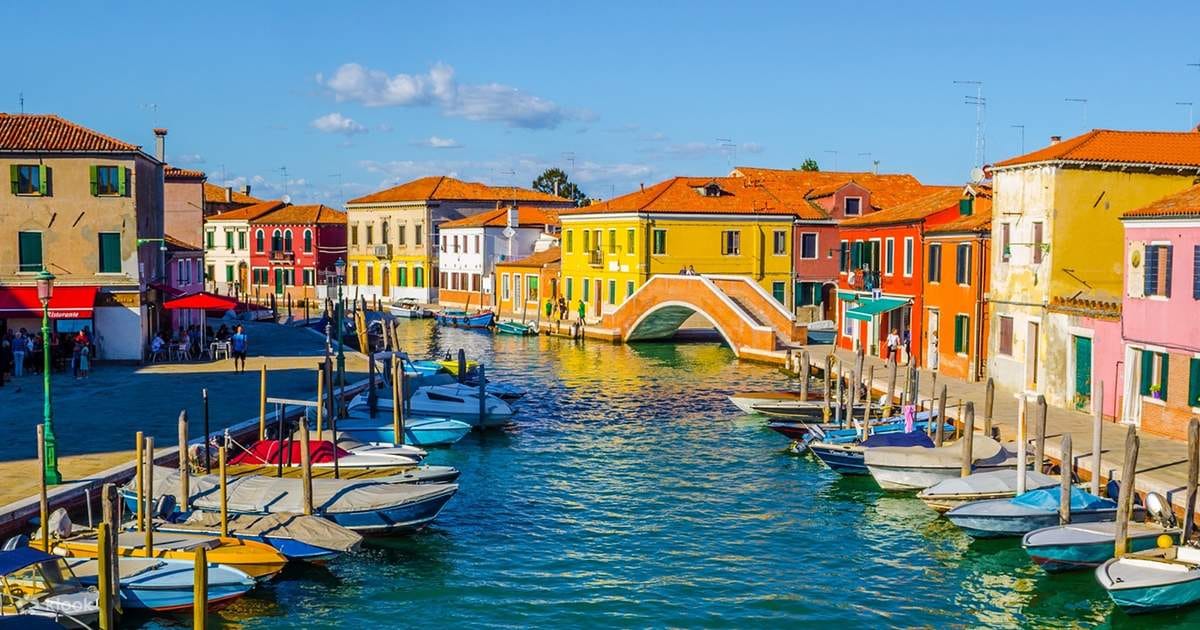 Colorful canal in Burano Venice with vibrant houses and reflections on water
