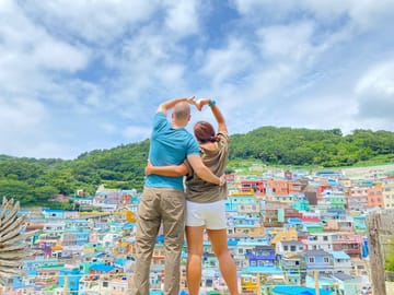 A couple enjoying the panoramic view from Gamcheon Culture Village.