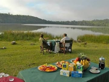 Private outdoor picnic setup along the peaceful shores of Lake Duluti.