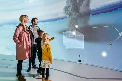 Family trying the interactive part of the Glaciers and Ice Cave exhibition at Perlan Museum