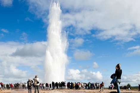 People overmatching Strokkur Geyser during South coast and northern lights tour
