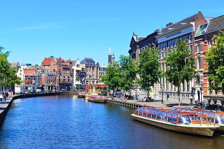 Canal view of tour boat in Amsterdam at Rokin