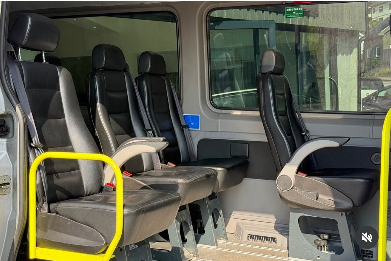 Clean, spacious black leather seats inside a premium heated tour minibus used for Tromsø Northern Lights chases.