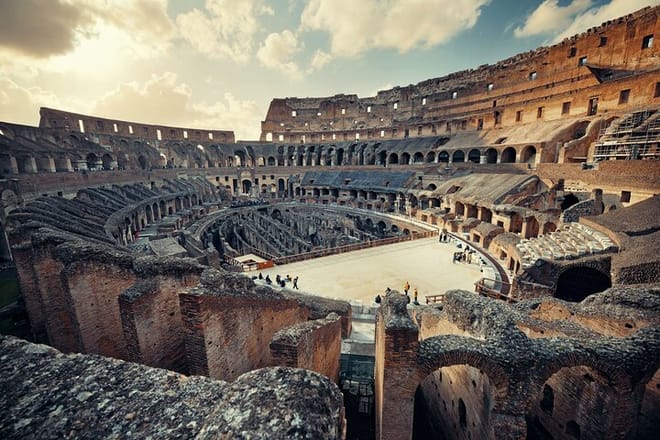 Panoramic view of Roman Colosseum interior at sunset