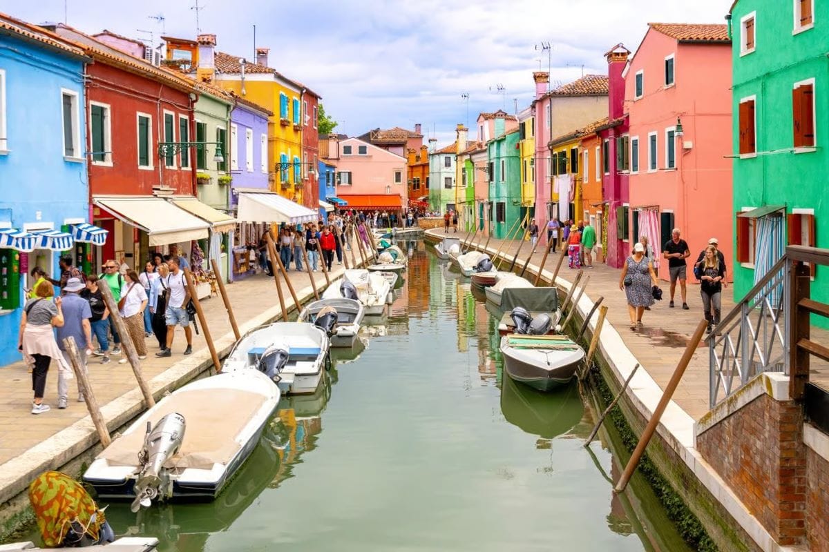 Colorful houses along a canal in Burano Venice