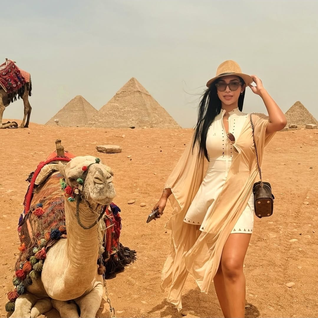 Female tourist standing at the panoramic viewpoint of the Giza Pyramids and Great Sphinx during a private Cairo day trip, capturing Egypt