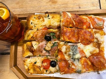 "Enjoy a delightful Italian aperitivo alongside mouthwatering pizza!"