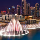 Serene lake reflecting the dancing fountains.