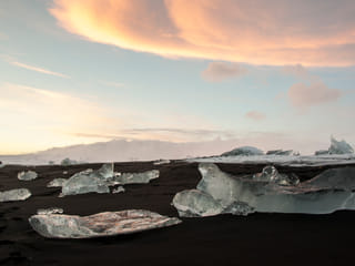Pieces of ice on black sand near Glacier Lagoon Iceland