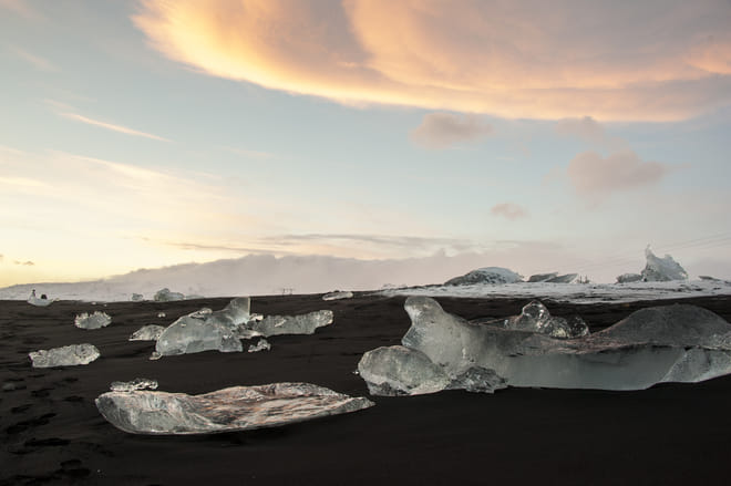Pieces of ice on black sand near Glacier Lagoon Iceland