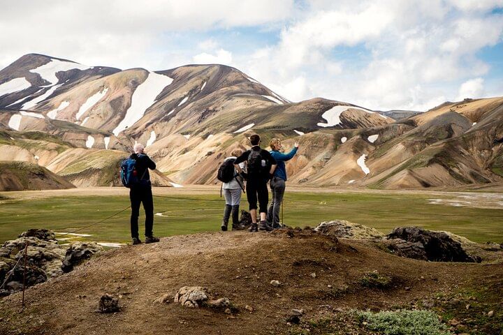People taking pictures of the colorful Rhyolite mountains
