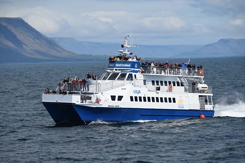 Whale watching boat sailing through Eyjafjörður Fjord in Iceland