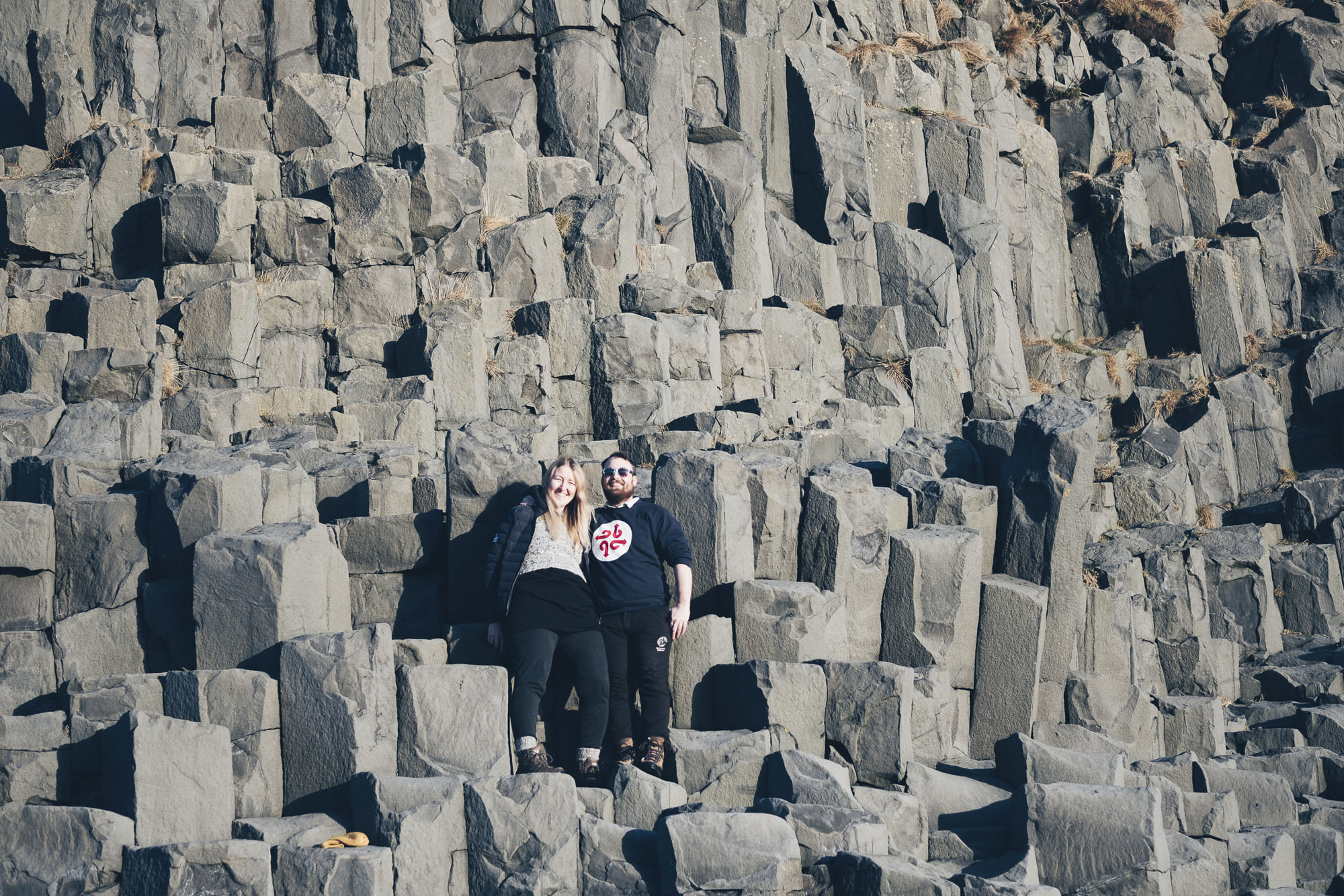 Becoming one with nature on top of basalt columns in Reynisfjara beach Iceland