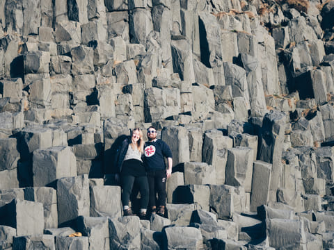Becoming one with nature on top of basalt columns in Reynisfjara beach Iceland