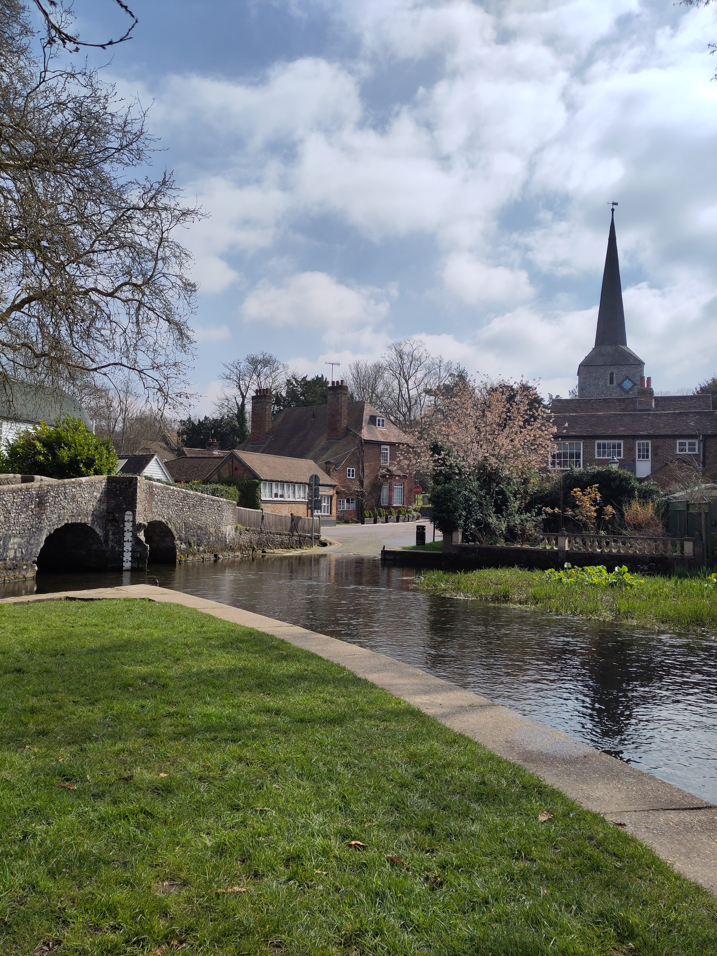 A river passing through a village with bridge and ford