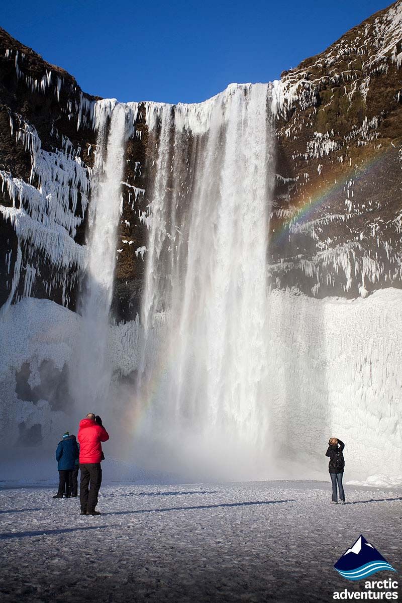People photographing waterfall during 2 day south coast tour Iceland