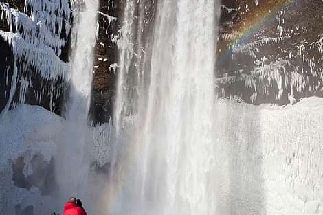 People photographing waterfall during 2 day south coast tour Iceland