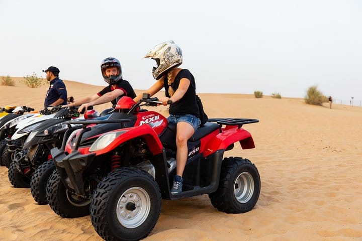 Travelers get ready to ride their quad bikes in the desert.
