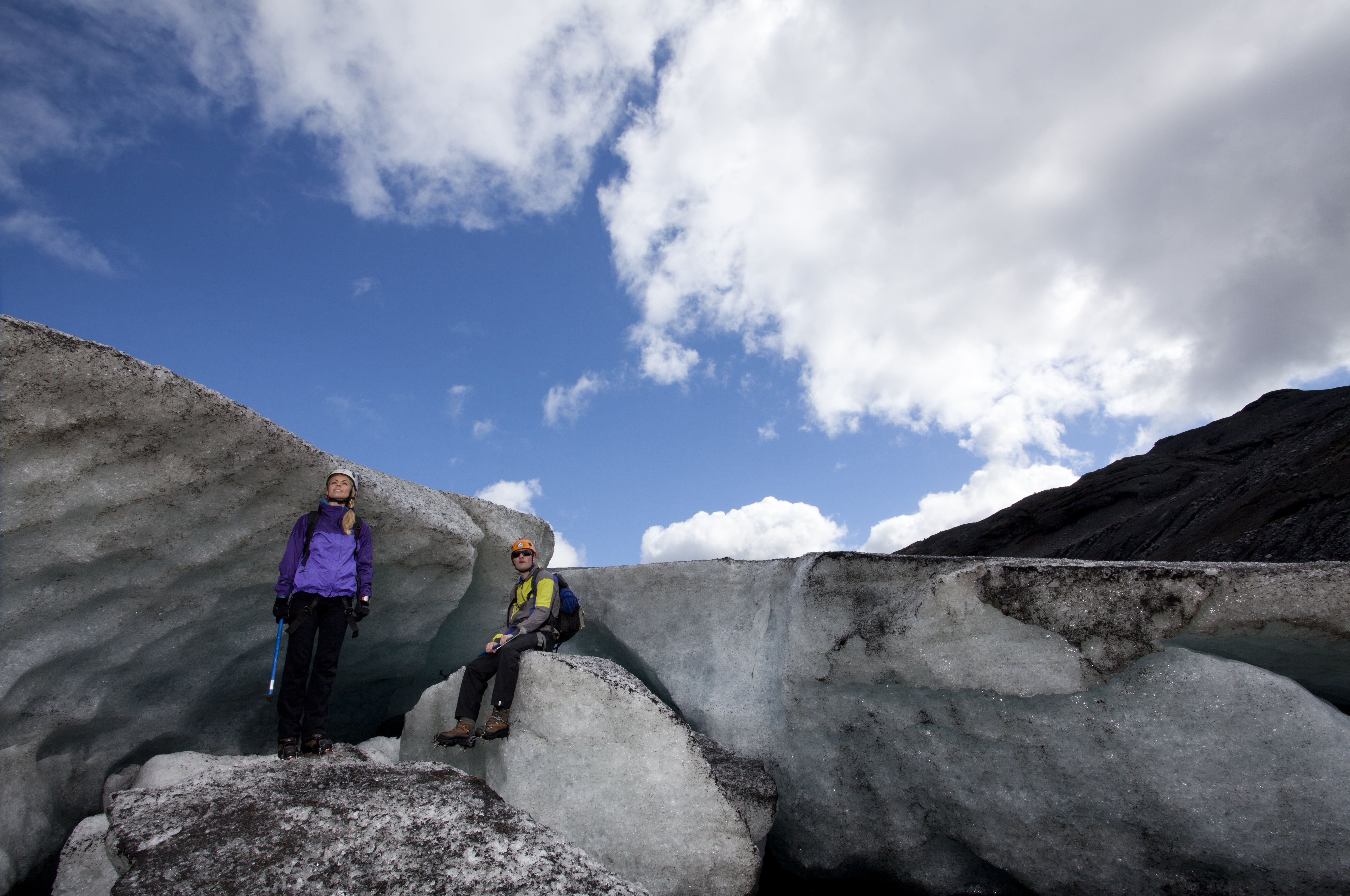 Couple of hikers posing next to the glacier