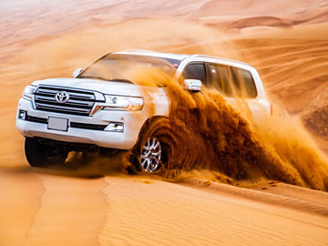 Morning Desert Safari with Camel Farm Visit & Sandboarding