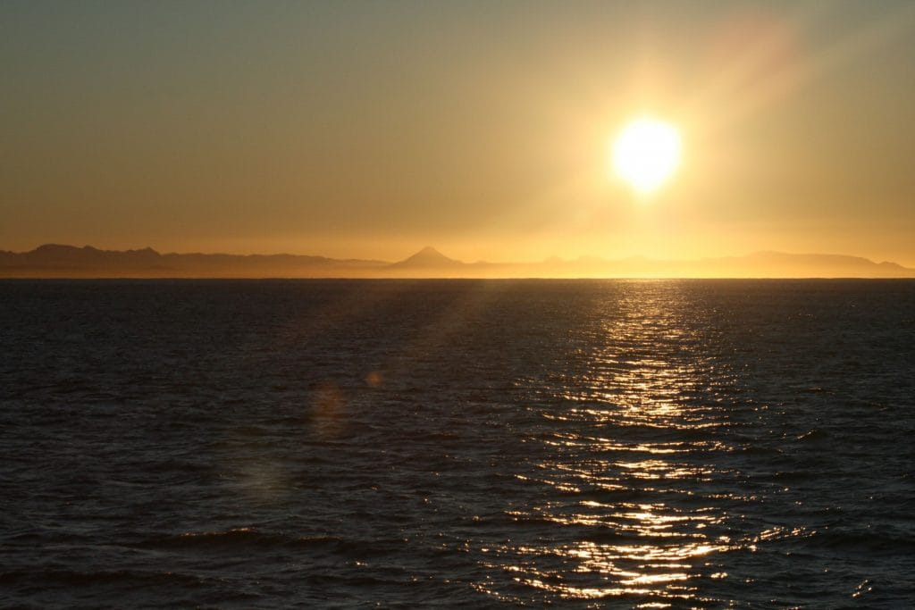 Sunset over the ocean viewed from a whale watching boat near Reykjavík