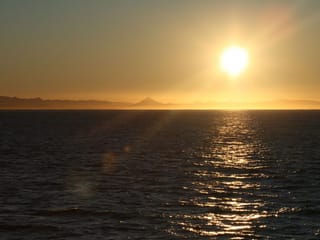 Sunset over the ocean viewed from a whale watching boat near Reykjavík