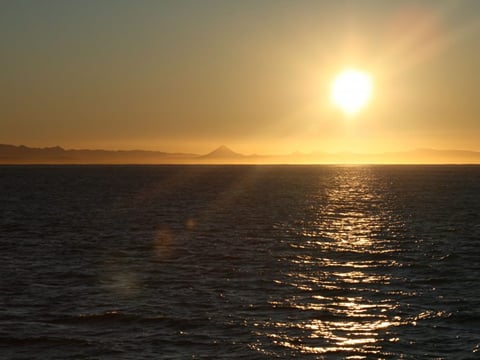 Sunset over the ocean viewed from a whale watching boat near Reykjavík
