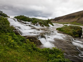 Fossabrekkur, a lesser-known gem where crystal-clear streams tumble through mossy fields